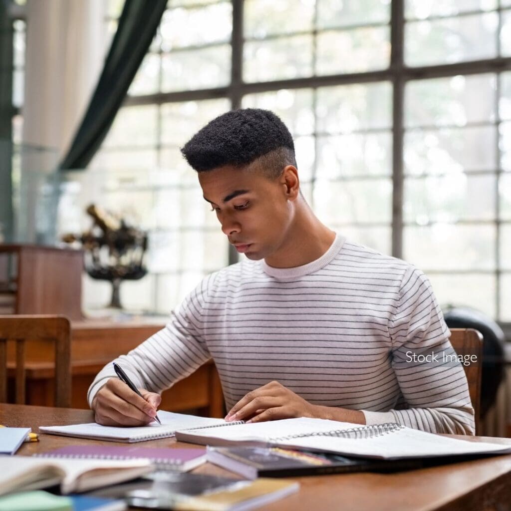 Guy with white striped top studying at University