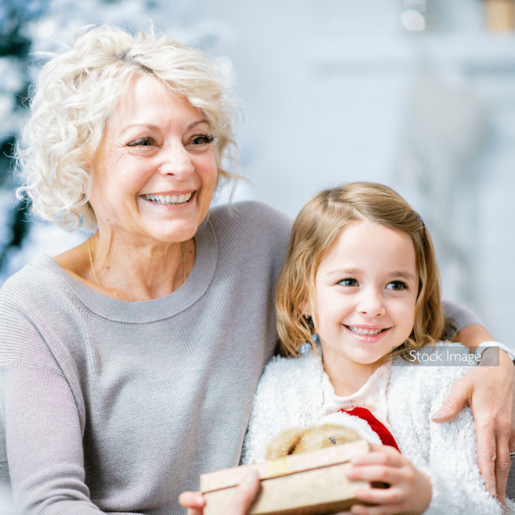 Grandmother and Granddaughter at Christmas time with Presents Smiling