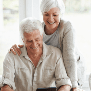 Elderly Man and Lady Looking at Laptop Screen Smiling Choosing Cataract Procedure Stock Image